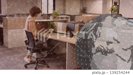 Woman wearing business casual retrieving purse from adjustable chair at cubicle desk, copy space Woman wearing business casual retrieving purse from adjustable chair at cubicle desk, copy space 139254244