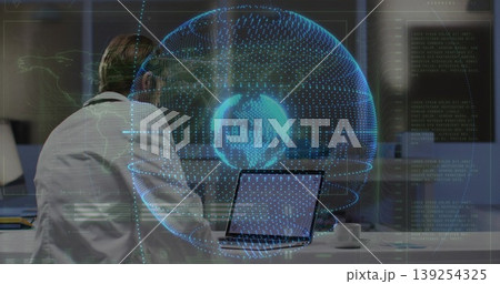 Displaying mid-adult man examining holographic globe while working on laptop at office, copy space Displaying mid-adult man examining holographic globe while working on laptop at office, copy space 139254325