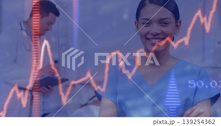 Smiling nurse in blue scrubs standing in hospital ward, with red line graph overlay, copy space 139254362