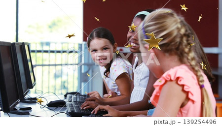 Typing three girls in pastel coral tops at school computer lab with keyboards, with floating stars Typing three girls in pastel coral tops at school computer lab with keyboards, with floating stars 139254496