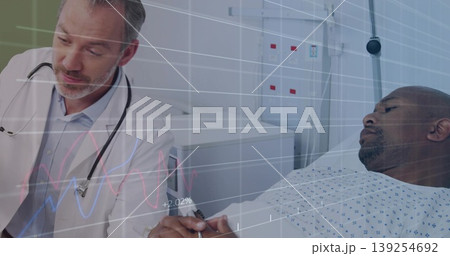 Examining mid-adult male patient wrist on bed in hospital room, with stethoscope clipboard Examining mid-adult male patient wrist on bed in hospital room, with stethoscope clipboard 139254692