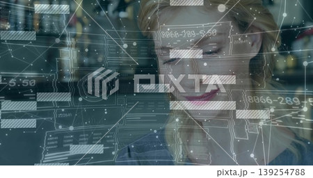 Analyzing female data analyst interacting with holographic data overlays at modern office desk Analyzing female data analyst interacting with holographic data overlays at modern office desk 139254788