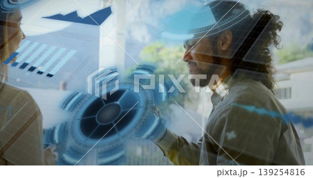 Gesturing man in button-up shirt interacting with hologram in office meeting room, stylus Gesturing man in button-up shirt interacting with hologram in office meeting room, stylus 139254816