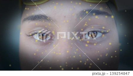 Showing female face with brown eyes and lashes in studio set, with sunglasses and glowing particles Showing female face with brown eyes and lashes in studio set, with sunglasses and glowing particles 139254847