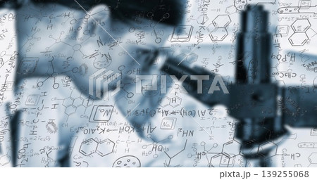 Highlighting compound microscope projecting chemical diagrams at lab bench, with notation overlays 139255068