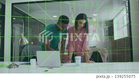 Leaning man and woman reviewing documents on desk in modern office, with laptop and sticky notes Leaning man and woman reviewing documents on desk in modern office, with laptop and sticky notes 139255075