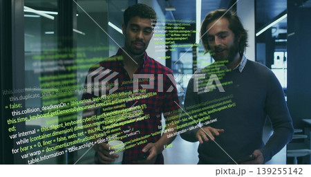 Reviewing code two developers wearing casual shirts using tablet in office with coffee mug, overlay 139255142