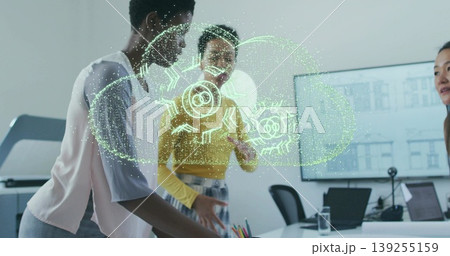 Collaborating four women examining green holographic cloud projection at office table with laptops Collaborating four women examining green holographic cloud projection at office table with laptops 139255159