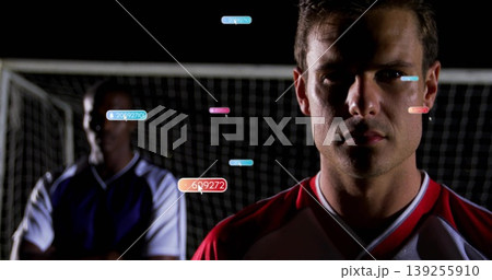 Tracking player wearing red-white jersey on night soccer field with net and data tags, copy space Tracking player wearing red-white jersey on night soccer field with net and data tags, copy space 139255910