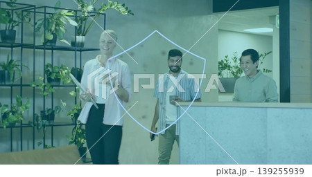 Walking group of professionals in office lobby, with smartphone, coffee mug and rolled document Walking group of professionals in office lobby, with smartphone, coffee mug and rolled document 139255939