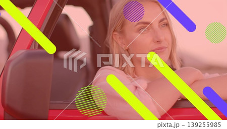 Leaning thoughtfully, woman gazing through driver window of red car, with door frame, side mirror Leaning thoughtfully, woman gazing through driver window of red car, with door frame, side mirror 139255985