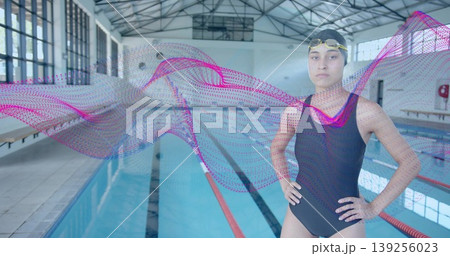 Adjusting goggles swimmer wearing racing suit on pool deck, with digital wave graphic, copy space Adjusting goggles swimmer wearing racing suit on pool deck, with digital wave graphic, copy space 139256023