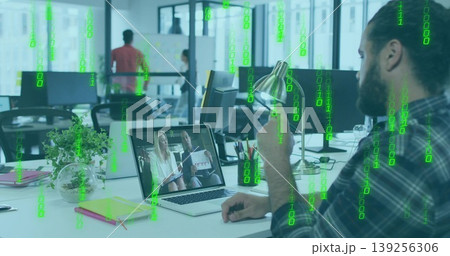 Bearded coder gesturing toward laptop during call at desk, with coffee mug, binary code, copy space 139256306