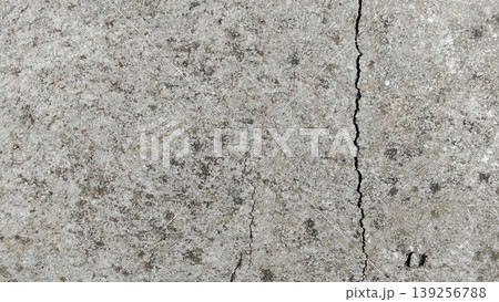 Cracked Concrete Wall with Moss Texture Shows Urban Weathering and Rough Surface 139256788