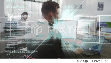 Typing developer wearing dark T-shirt writing code on laptop at wooden desk, with external monitor Typing developer wearing dark T-shirt writing code on laptop at wooden desk, with external monitor 139256938