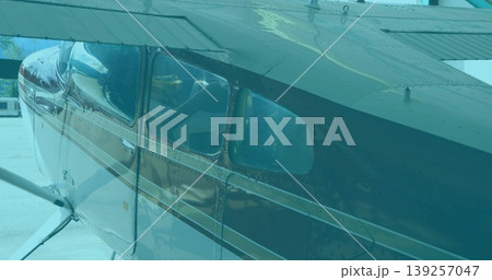Showing small aircraft fuselage on airport ramp, with cabin windows and wing support struts Showing small aircraft fuselage on airport ramp, with cabin windows and wing support struts 139257047