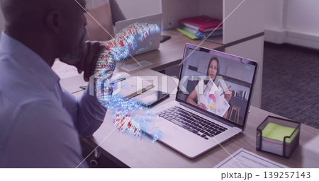 Watching man in shirt viewing woman presenting pie chart on laptop at desk, with data swirl 139257143