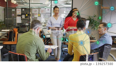 Five business professionals collaborating in office, with charts, sticky notes and data icons Five business professionals collaborating in office, with charts, sticky notes and data icons 139257380