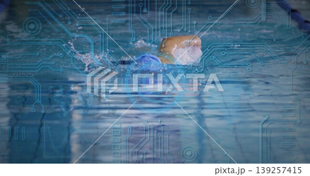 Gliding swimmer performing freestyle stroke in pool lane, with swim cap goggles, circuit overlay Gliding swimmer performing freestyle stroke in pool lane, with swim cap goggles, circuit overlay 139257415