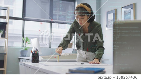 Designer drawing on blueprint with metal compass at design studio, including scale model Designer drawing on blueprint with metal compass at design studio, including scale model 139257436