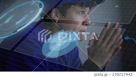 Sitting woman interacting with holographic panels at workstation, with circular charts Sitting woman interacting with holographic panels at workstation, with circular charts 139257443