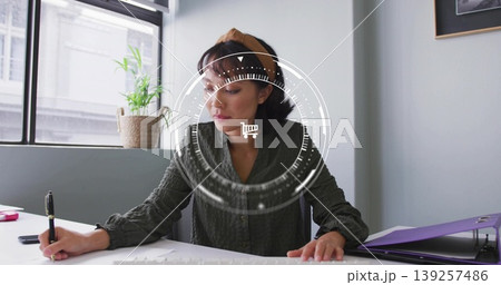 Writing woman at desk by window, using black pen, accessories and plant under shopping cart overlay Writing woman at desk by window, using black pen, accessories and plant under shopping cart overlay 139257486