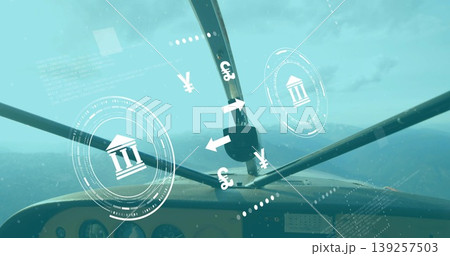 Showing cockpit panel and windshield struts flying over mountain peaks, with HUD financial icons 139257503