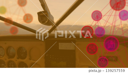 Displaying cockpit instrument panel featuring gauges over snowy mountains, with network overlay 139257559