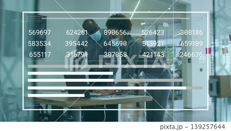 Reviewing laptop data at conference table, colleagues wearing surgical face masks with data overlay Reviewing laptop data at conference table, colleagues wearing surgical face masks with data overlay 139257644