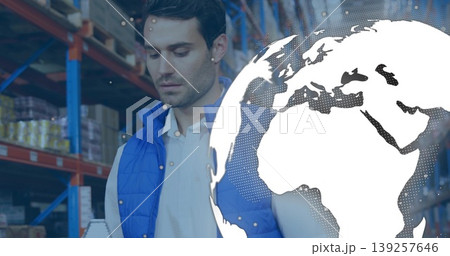 Reviewing inventory worker wearing blue vest in warehouse aisle with stacked boxes, globe overlay Reviewing inventory worker wearing blue vest in warehouse aisle with stacked boxes, globe overlay 139257646