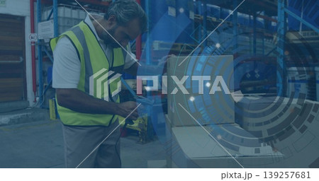 Scanning worker wearing yellow vest using handheld barcode scanner on box in warehouse, copy space Scanning worker wearing yellow vest using handheld barcode scanner on box in warehouse, copy space 139257681