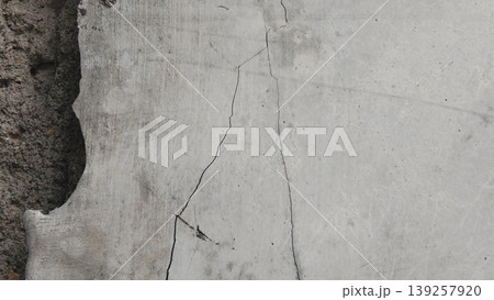 The concrete walls are textured and weathered with jagged cracks. 139257920