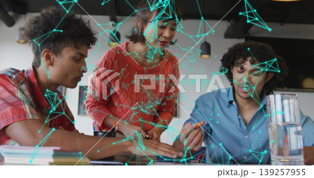 Leaning coworkers marking printed documents on desk in office, colored markers and network overlay Leaning coworkers marking printed documents on desk in office, colored markers and network overlay 139257955