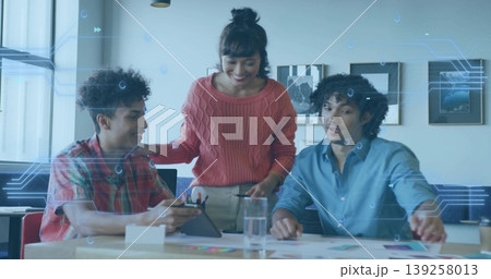 Pointing woman guiding colleagues at table in meeting room with tablet stylus and color swatches Pointing woman guiding colleagues at table in meeting room with tablet stylus and color swatches 139258013