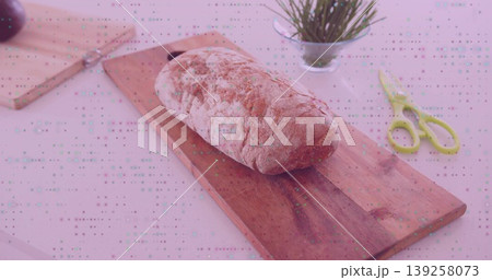 Crusty loaf of bread resting on wooden cutting board at kitchen counter, with steel knife, scissors Crusty loaf of bread resting on wooden cutting board at kitchen counter, with steel knife, scissors 139258073