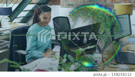 Focusing woman wearing teal blouse typing on keyboard in open plan office with monitor, copy space Focusing woman wearing teal blouse typing on keyboard in open plan office with monitor, copy space 139258112