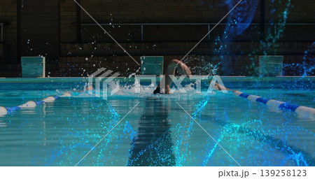 Swimming man performing freestyle stroke in lap pool, with lane dividers and starting blocks Swimming man performing freestyle stroke in lap pool, with lane dividers and starting blocks 139258123
