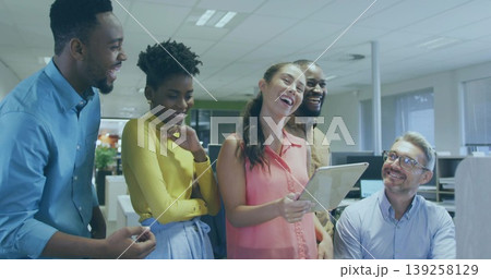 Gathering five colleagues in business attire collaborating in open-plan office, with digital tablet 139258129