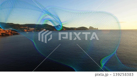 Flowing digital mesh wave overlay sweeping across seaside at sunset with rocky coastline and hills 139258383