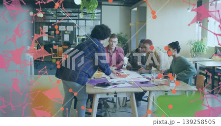 Pointing team members discussing design concepts around meeting table, with tablet and smartphone Pointing team members discussing design concepts around meeting table, with tablet and smartphone 139258505