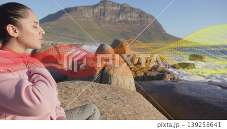 Woman in activewear breathing on boulders by sea, waves, mountain, wave graphic overlay, copy space Woman in activewear breathing on boulders by sea, waves, mountain, wave graphic overlay, copy space 139258641
