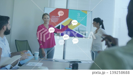 Presenting project lead in magenta blouse showing infographic on screen in boardroom, with papers Presenting project lead in magenta blouse showing infographic on screen in boardroom, with papers 139258688