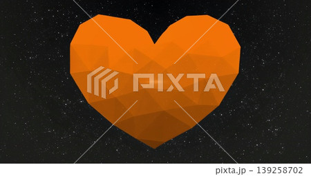 Floating faceted orange heart shape rotating in deep space, with countless tiny white stars 139258702