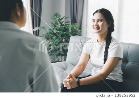 Mental health recovery concept with woman talking to therapist during counseling session at home, showing progress, trust, emotional healing, positive communication, hope and psychological support. 139258952