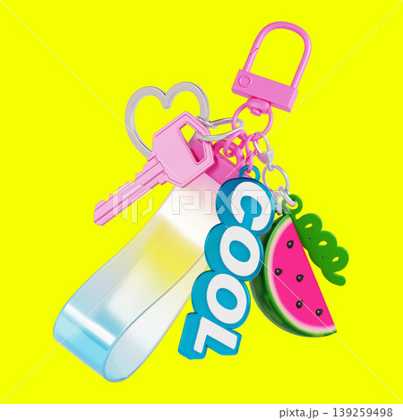 A keychain displays a key and colorful charms, including a bright pink heart, the word COOL, and a watermelon slice. It is on a yellow background that enhances the colors. A keychain displays a key and colorful charms, including a bright pink heart, the word COOL, and a watermelon slice. It is on a yellow background that enhances the colors. 139259498