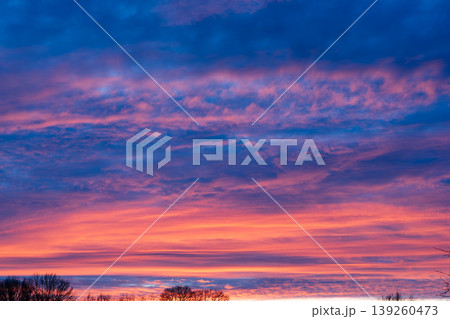 Beautiful Dramatic Sunset Sky with Vibrant Orange Pink and Blue Clouds 139260473