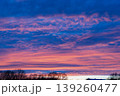 Stunning twilight sky with pink cirrus clouds over tree silhouettes 139260477