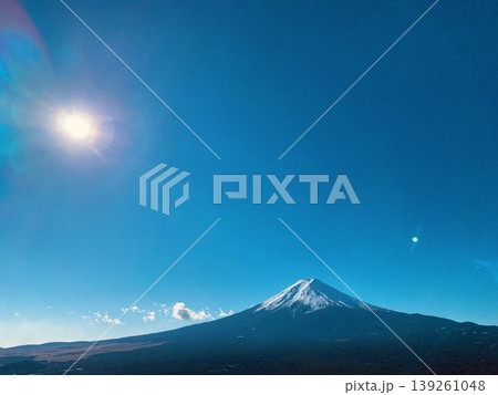 Mount Fuji with sunlight flare in clear blue sky, dramatic landscape in Japan Mount Fuji with sunlight flare in clear blue sky, dramatic landscape in Japan 139261048
