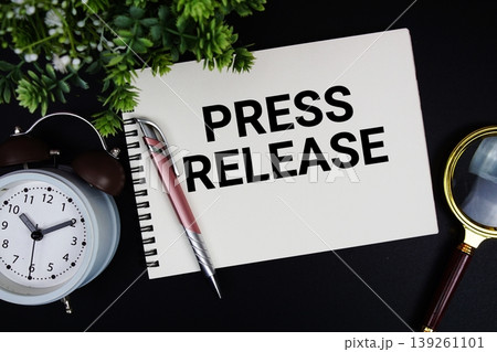 Press Release text with alarm clock and magnifying glass 139261101