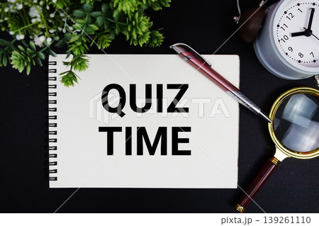 Quiz time text with alarm clock and magnifying glass Quiz time text with alarm clock and magnifying glass 139261110